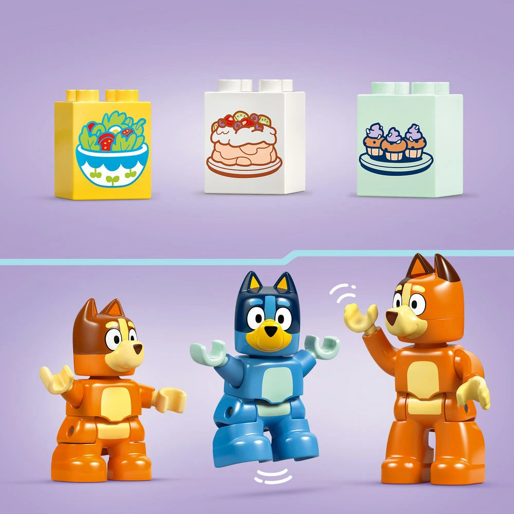 LEGO Bluey Family House set 10459 featuring three colorful building block boxes with food designs and three articulated LEGO figures including an orange cat character, a blue dog character, and another orange cat character against a purple background