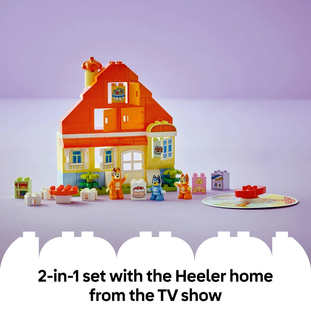 LEGO Bluey's Family House playset featuring a colorful red and yellow two-story house with orange roof, yellow lighthouse tower, and multiple windows, surrounded by LEGO minifigures including Bluey and Bingo characters, small building blocks in various colors, a memory game board, and accessories against a purple background