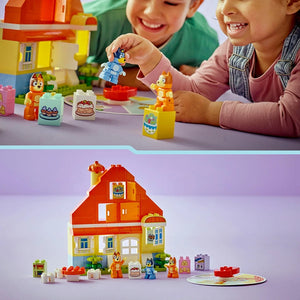 Two children playing with Lego Bluey's Family House set featuring a red and yellow brick house with multiple rooms, colorful minifigures including Bluey characters, green plants, and a memory game board on a purple surface, with the complete set displayed below showing all components and pieces
