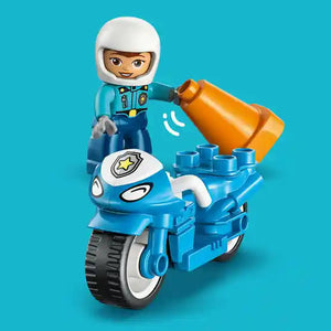 LEGO Duplo blue police motorcycle with white-helmeted officer figure, orange siren light, and black wheels on turquoise background