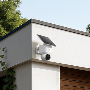 Solar-powered security camera on a house exterior with greenery in the background