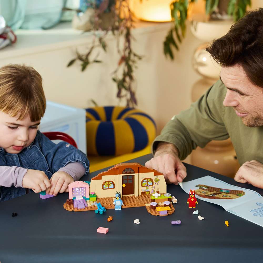 LEGO Bluey School with Rusty and Bluey 11221 - a child building the set. 106 pieces. Ages 4+.