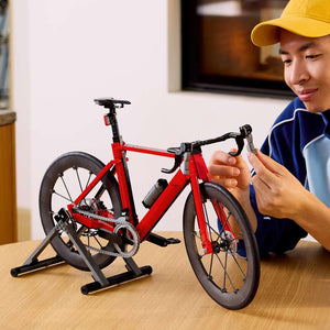 LEGO Icons Road Bike 11380 - a child playing with the finished build. 1015 pieces. Ages 18+.