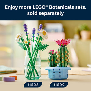 LEGO Botanicals Daisies set 11508 featuring white daisies with yellow centers, purple lavender flowers, and green stems arranged in a clear glass vase displayed on a wooden surface