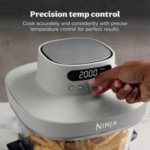 Ninja CRISPi PRO 7 in 1 XL Glass Air Fryer in white and bone grey with digital display showing 20:00, featuring precision temperature control buttons being adjusted by a hand, displayed on marble countertop with food visible in glass cooking vessel