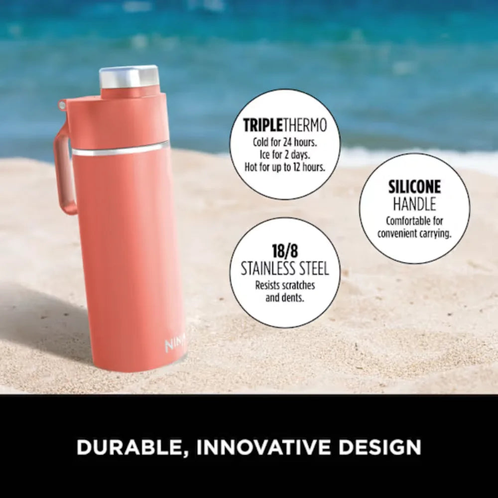 Coral pink Ninja Thirsti insulated travel bottle with silicone handle displayed on beach sand with ocean background, featuring triple thermo technology, 18/8 stainless steel construction, and product feature callouts