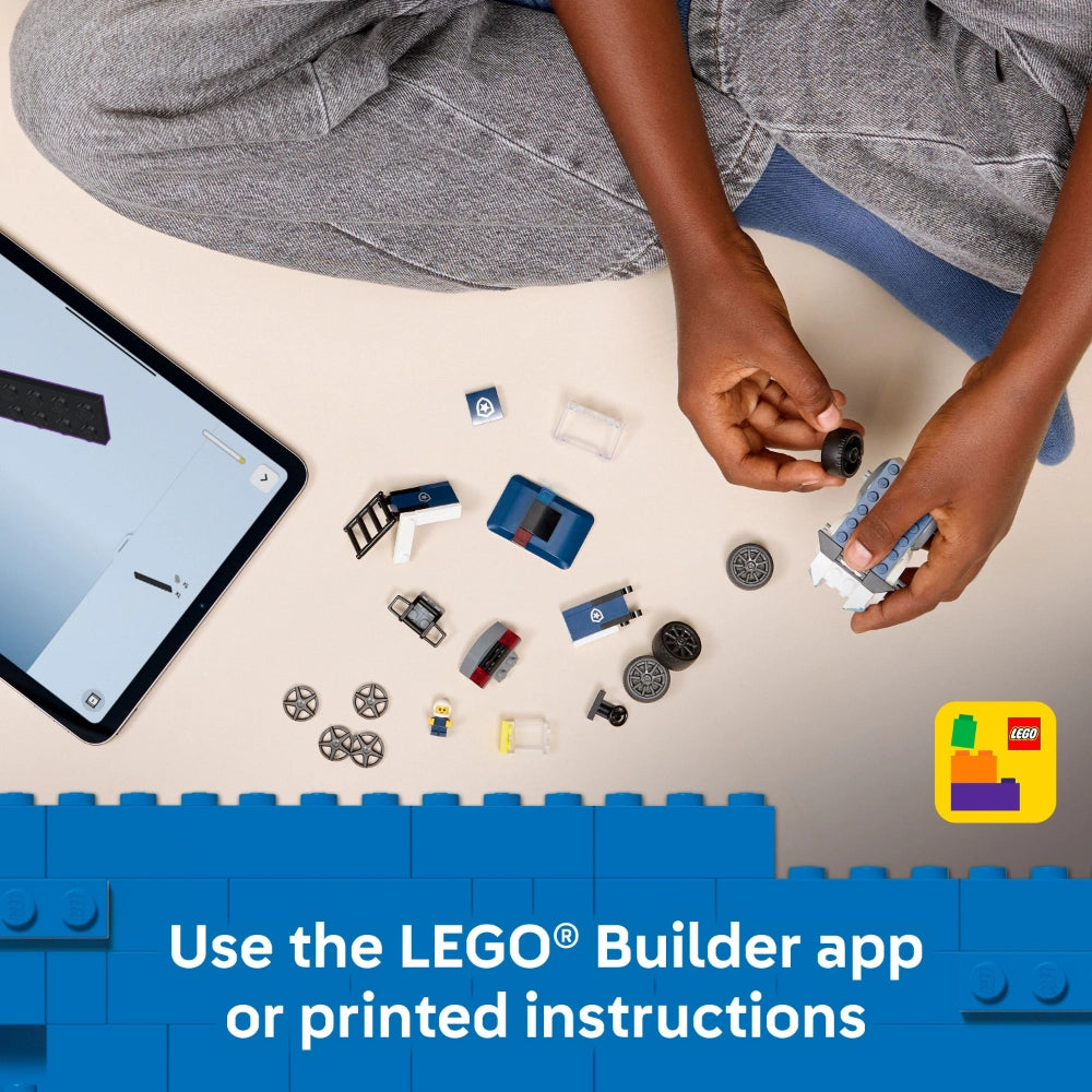 Overhead flat lay of LEGO 60481 Police Truck set components including blue and white brick pieces, minifigure, wheels, and other small parts arranged on a white surface with a child's hands assembling pieces, alongside a smartphone showing the LEGO Builder app, with blue LEGO brick border and app logo in bottom right corner