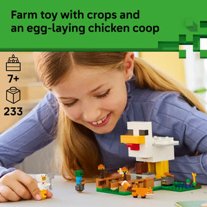 Young girl with reddish-brown hair playing with LEGO Minecraft Chicken Farm set featuring a white pixelated chicken coop, colorful building blocks in green, yellow, orange and brown, small LEGO figures and farm animals on a white surface, with green farmland base, age 7+ rating and 233 piece count displayed