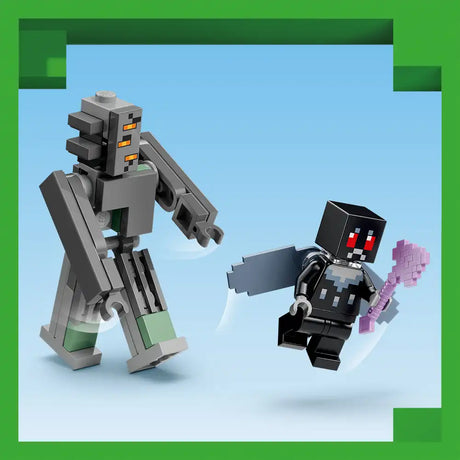LEGO Minecraft The Pale Garden set 21586 featuring a large grey stone Warden minifigure with orange eyes and green accents beside a smaller black Enderman minifigure holding a pink block, displayed against a light blue background with green border frame