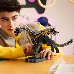 LEGO Minecraft The Ender Dragon 21595 - a child playing with the finished build. 710 pieces. Ages 10+.