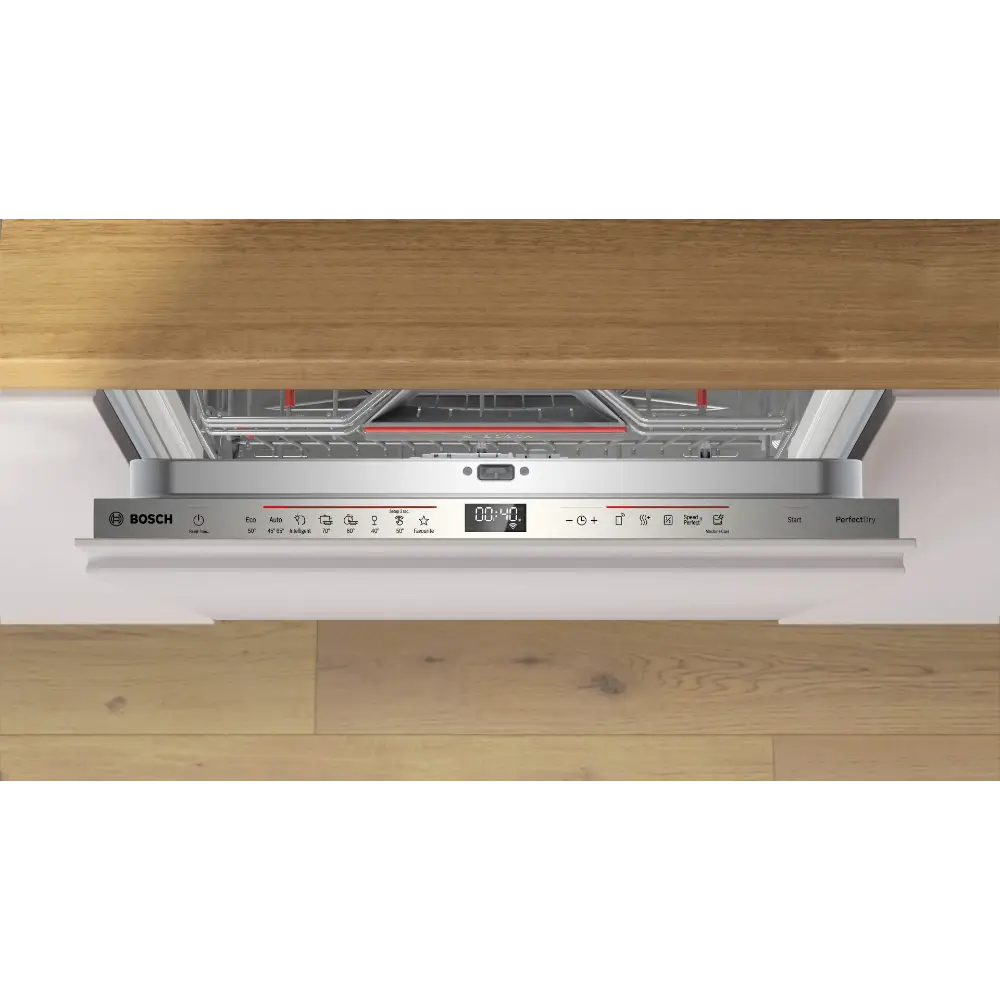 Bosch Series 6 integrated dishwasher with stainless steel control panel featuring digital display, installed under wooden countertop in modern kitchen, showing closed door with white fascia and partial view of interior rack system with red handles