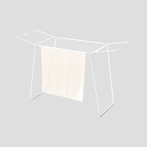 White metal clothes drying rack with expandable hanging rails and cream fabric panel, featuring sturdy A-frame legs and multiple horizontal bars for air-drying laundry