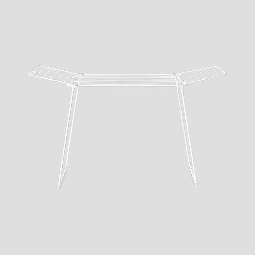 White metal clothes drying rack airer with two angled wings and four legs, front view on neutral background