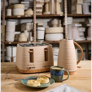 Morphy Richards Clay Felspar 4 slice toaster in natural wood and cream finish displayed on wooden surface with matching kettle, blue ceramic mug and plate of toast, shelving with kitchenware visible in background