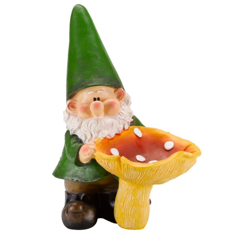 Garden gnome ornament with white beard and rosy cheeks wearing a tall green pointed hat, holding a red and white spotted mushroom with yellow stem, standing on a brown base