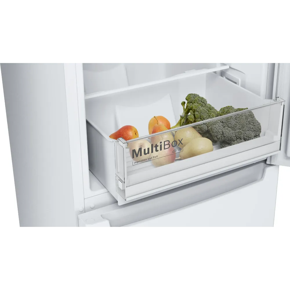 Open refrigerator drawer showing Bosch Series 2 fridge freezer with MultiBox storage compartment containing fresh vegetables including broccoli, apples, and potatoes on white shelving
