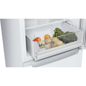 Open refrigerator drawer showing Bosch Series 2 fridge freezer with MultiBox storage compartment containing fresh vegetables including broccoli, apples, and potatoes on white shelving