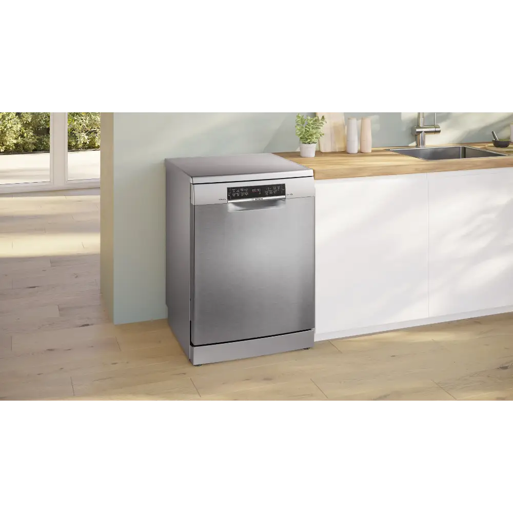 Bosch Series 6 stainless steel freestanding dishwasher with 14 place setting capacity positioned in a modern kitchen with white cabinetry, wooden countertop and natural lighting from adjacent windows