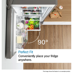 Overhead view of Bosch Series 2 fridge freezer with 90-degree opening angle showing fully stocked interior with fresh vegetables, dairy products and frozen items, displaying Perfect Fit feature on wooden kitchen countertop next to cutting board with fresh ingredients