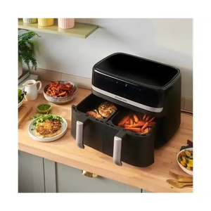 Russell Hobbs Satisfry Dual Basket Air Fryer 9 Litre in black and silver displayed on wooden kitchen counter with cooked food in baskets, surrounded by prepared dishes and kitchen accessories