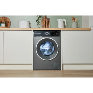 Bosch Series 6 grey washing machine with 10kg capacity and 1400 spin integrated into white kitchen cabinetry with wooden shelf and accessories above
