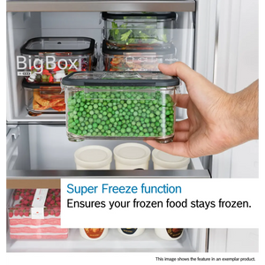 Bosch Series 2 fridge freezer with Super Freeze function demonstration showing a hand holding a clear plastic container of frozen green peas with black lid, displaying organized freezer compartment containing various food storage containers and frozen items