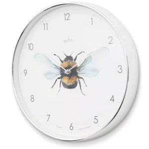 Acctim Society Bee silver analogue wall clock featuring watercolor bee illustration in center with black, yellow and blue tones, white dial face with gray numbers and hands, round silver metal frame, suitable for home decor