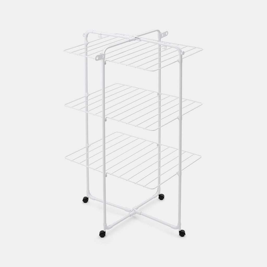 White metal clothes airer tower with three horizontal shelves, X-frame base with four black caster wheels, featuring 23 metres of drying space with parallel drying rails