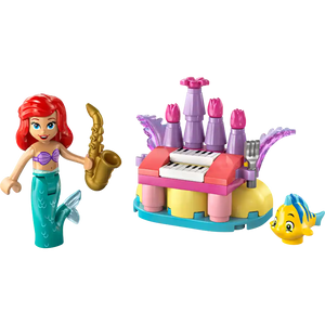LEGO Disney Ariel and Flounder's Birthday Music Fun set featuring red-haired mermaid minifigure with purple bikini top and turquoise tail holding gold saxophone, colorful castle structure with purple towers pink details yellow base blue platform white keyboard and purple organ pipes, and yellow Flounder fish minifigure