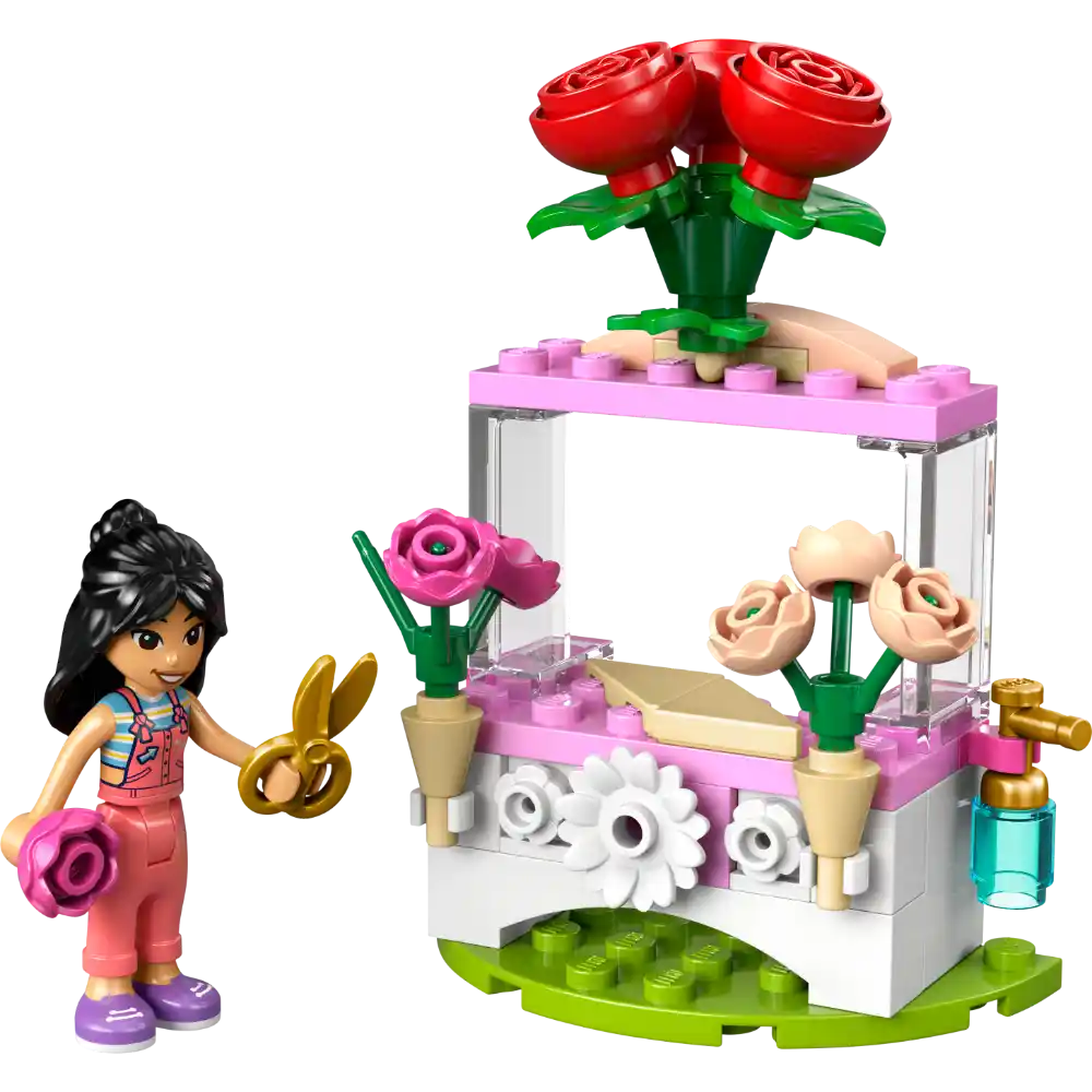 LEGO Friends Flower Stand set 30721 featuring a minifigure with black hair in colorful outfit, golden scissors, pink and white flower cart with red roses, pink blooms, cream flowers in tan pots, white daisy details, and green baseplate