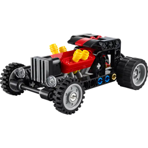 LEGO Technic Hot Rod Car 30723 with red engine block, black and red chassis, yellow exhaust pipes, silver and black wheels, and blue and gold accent details against white background
