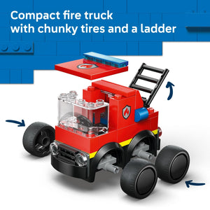 A red LEGO fire truck with chunky black tires, featuring a transparent cabin with visible steering wheel, blue light bar on top, black ladder attached to the side, and yellow stripe detailing on the lower body, displayed against a blue LEGO background
