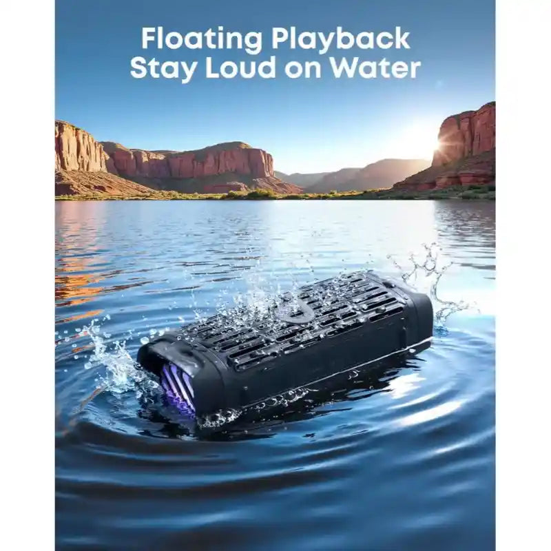 Soundcore Boom 3i black portable Bluetooth speaker floating in water with purple accent lights, demonstrating water resistance in a scenic canyon lake setting