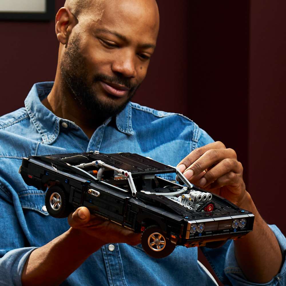 LEGO Technic Fast and Furious Dodge Charger R/T Car 42231 - a child playing with the finished build. 1516 pieces. Ages 18+.