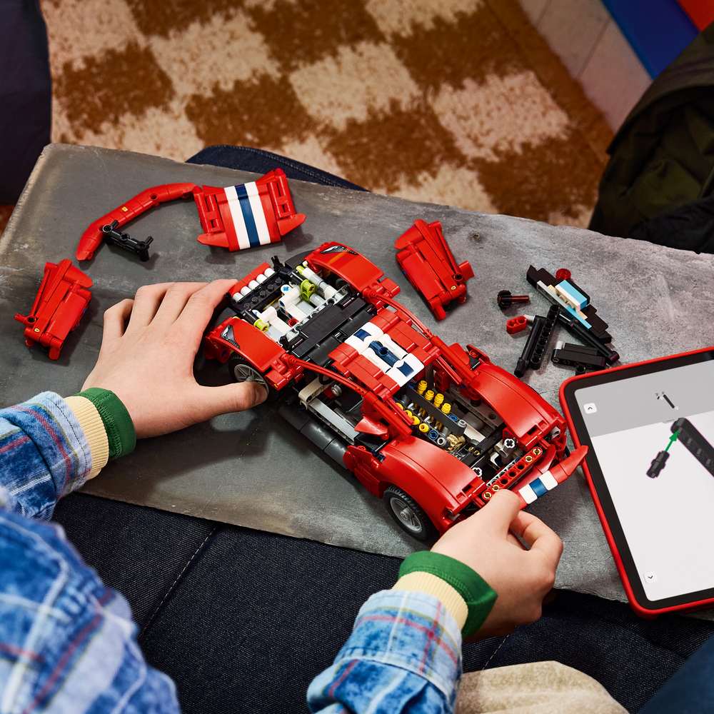 LEGO Technic Ferrari 488 Pista Car 42235 - a child building the set. 882 pieces. Ages 9+.
