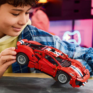 LEGO Technic Ferrari 488 Pista Car 42235 - a child playing with the finished build. 882 pieces. Ages 9+.