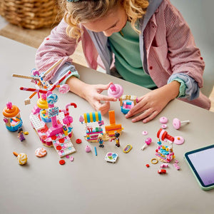LEGO Friends Candy & Cupcake Ferris Wheel 42700 - a child building the set. 602 pieces. Ages 7+.