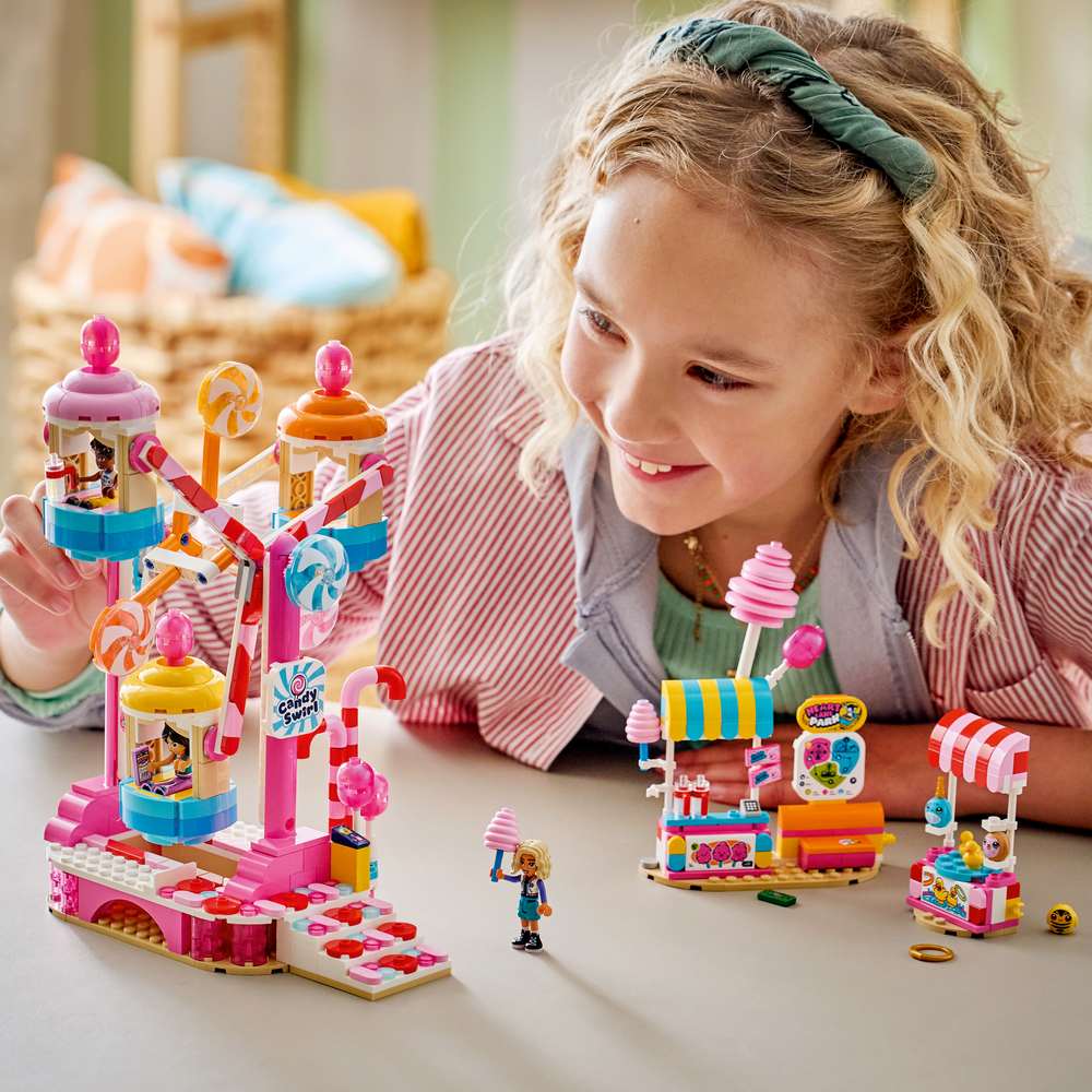 LEGO Friends Candy & Cupcake Ferris Wheel 42700 - a child playing with the finished build. 602 pieces. Ages 7+.