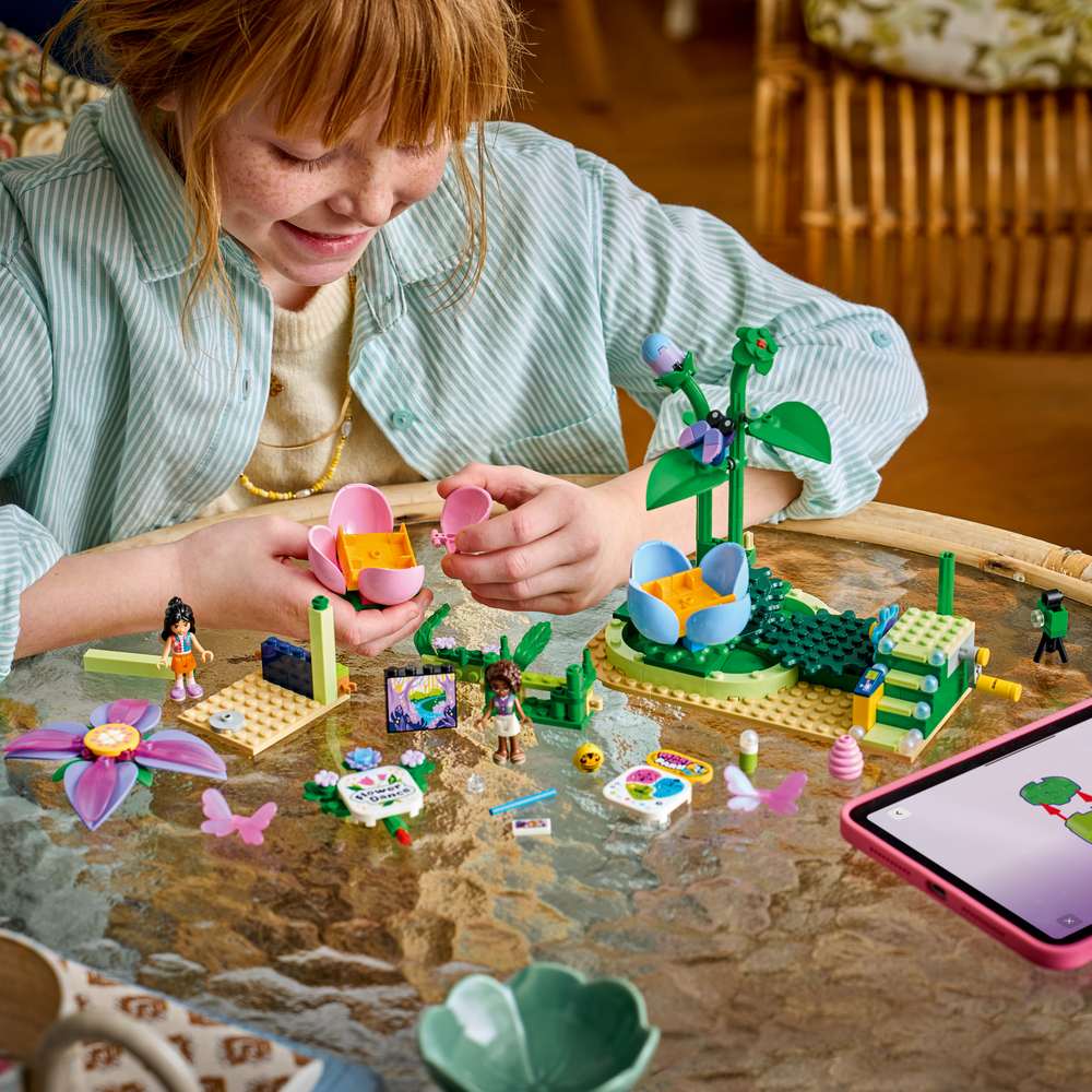 LEGO Friends Spinning Flower & Fairy Teacup Ride 42702 - a child building the set. 321 pieces. Ages 7+.