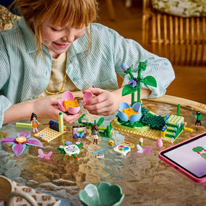 LEGO Friends Spinning Flower & Fairy Teacup Ride 42702 - a child building the set. 321 pieces. Ages 7+.