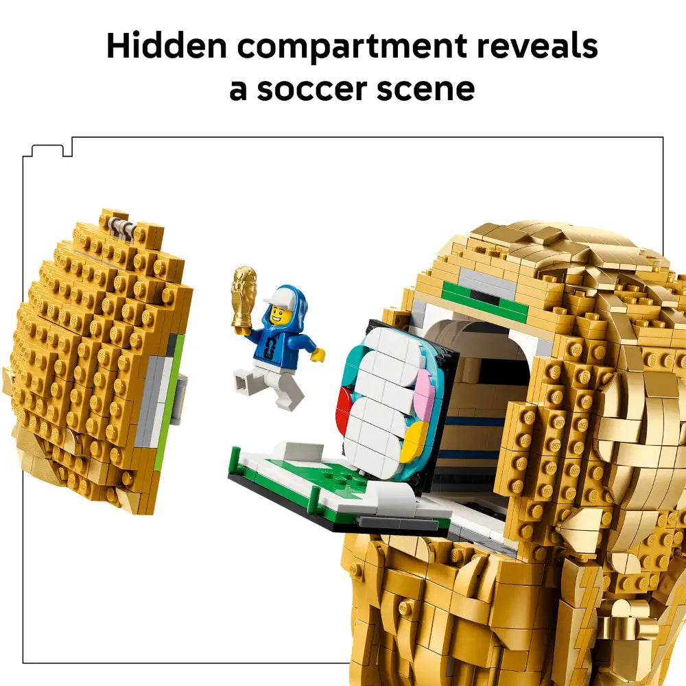 LEGO FIFA World Cup Trophy set 43020 featuring gold brick construction with hidden compartment revealing a soccer scene, blue minifigure holding golden trophy, and colorful goalkeeper figure on green field