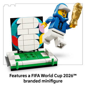 LEGO FIFA World Cup 2026 Official Trophy set 43020 featuring a blue and yellow minifigure holding a golden trophy, colorful rotating display mechanism with white tiles, and green and white football pitch base