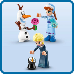 LEGO Frozen minifigures including Olaf the snowman with carrot nose, Elsa in dark blue dress, Anna in light blue winter outfit with hat, and small penguin Pabbie figure displayed against white background