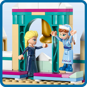 LEGO Arendelle Frozen Castle set 43265 featuring two minifigures with blonde and white hair in blue and dark navy outfits holding a golden egg, set within a turquoise and cream colored castle entrance with pink and magenta accents