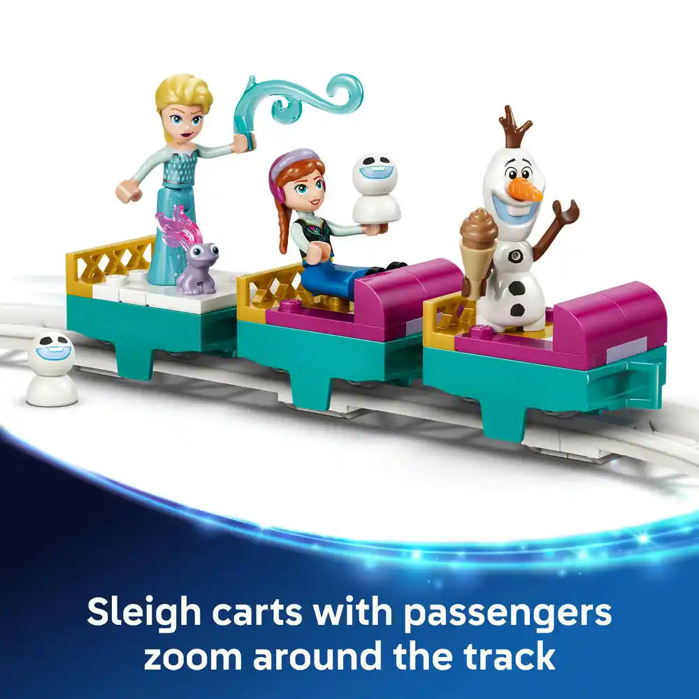 LEGO Disney Frozen ice castle playset featuring Elsa minifigure with turquoise magic staff, Anna with snowman Olaf, and three turquoise and magenta sleigh carts on white track with small snowball character figures