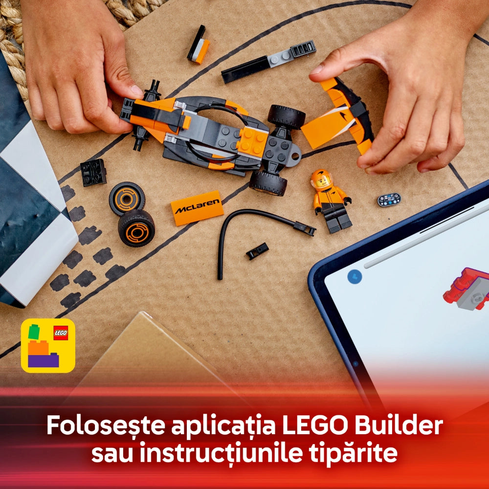 Child's hands assembling an orange and black LEGO McLaren Formula 1 race car set on a beige surface, with instruction manual, minifigure driver, wheels, and building pieces visible, alongside a smartphone displaying LEGO Builder app instructions