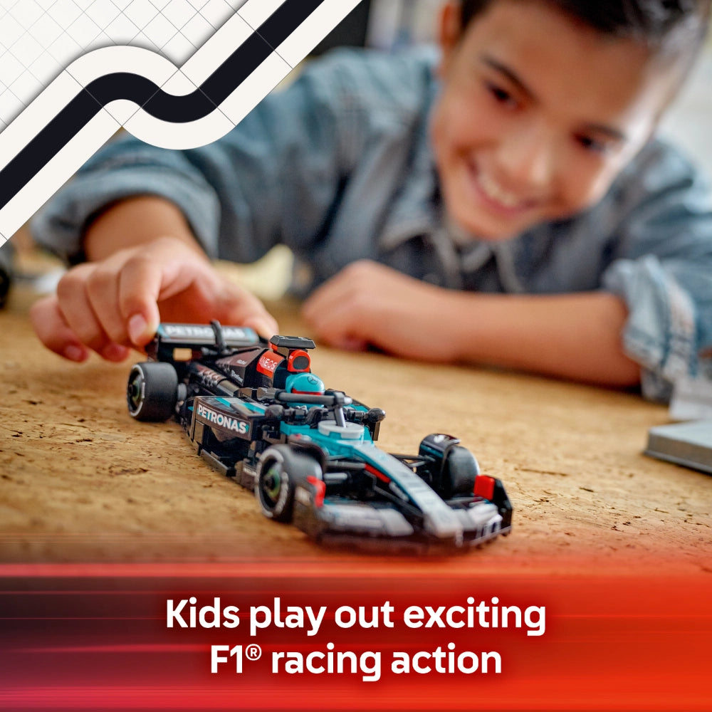 A young child playing with a black, turquoise and red LEGO Mercedes-AMG F1 race car model on a wooden surface, with the child's hand reaching toward the toy car, set against a light background with geometric design elements and red banner text reading Kids play out exciting F1 racing action