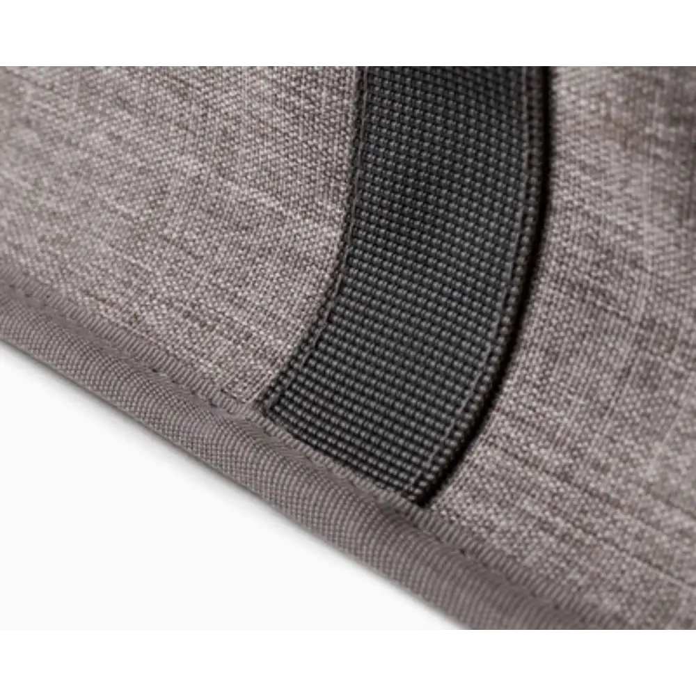 Close-up detail of grey fabric laundry basket showing woven textile material with black nylon handles and reinforced stitching
