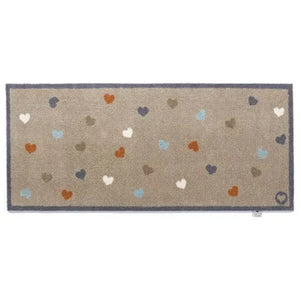 Hug Rug runner mat 65cm x 150cm with beige base and scattered heart pattern in white, cream, orange, blue, navy and grey tones, featuring dark blue border