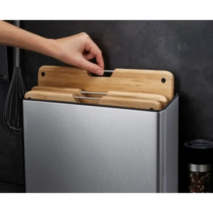 Joseph Joseph Folio Steel Bamboo 3 Piece Chopping Board Set with stainless steel container and natural bamboo boards being removed by hand, displayed against dark background with kitchen utensils